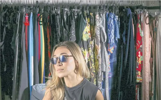  ?? Rick Loomis Los Angeles Times ?? DESIGNER Alana Hadid’s “closet” is a bedroom for her gowns as well as other clothes arranged by color and style. She has launched shirt, jacket and sunglass labels.