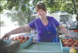  ?? BEA AHBECK/NEWS-SENTINEL ?? Fruit Bowl owner Denene Lucchetti works at the family owned Fruit Bowl in Stockton on Friday.. The market is celebratin­g its 70th anniversar­y.