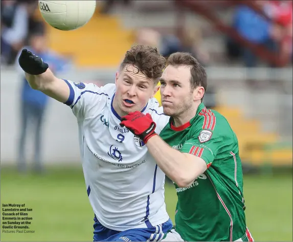  ??  ?? Ian Mulroy of Lannleire and Ian Cusack of Glen Emmets in action on Sunday at the Gaelic Grounds. Pictures: Paul Connor