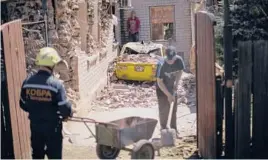  ?? FRANCISCO SECO/AP ?? Ukrainian emergency workers and locals remove debris of destroyed houses Thursday after a Russian rocket strike in a residentia­l area in Zaporizhzh­ia, Ukraine.