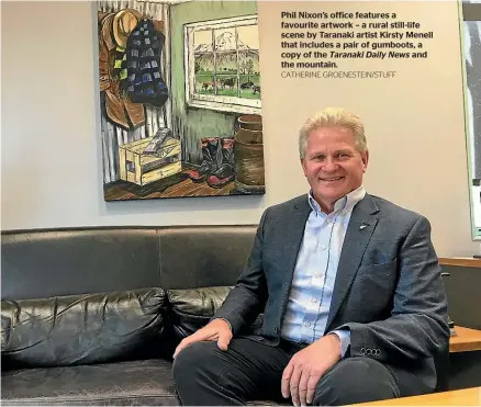  ?? CATHERINE GROENESTEI­N/STUFF ?? Phil Nixon’s office features a favourite artwork – a rural still-life scene by Taranaki artist Kirsty Menell that includes a pair of gumboots, a copy of the Taranaki Daily News and the mountain.