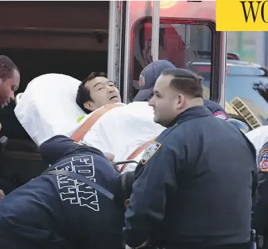  ?? MARK LENNIHAN / THE ASSOCIATED PRESS ?? Emergency personnel carry a man into an ambulance after a motorist drove onto a busy bicycle path near the World Trade Center memorial and struck several people on Tuesday afternoon in New York.