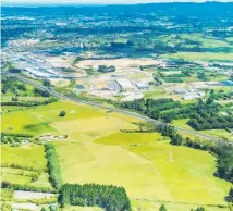  ??  ?? Most of the land between the motorway and tree lines in this aerial view encompasse­s the 43ha Whenuapai land block for sale.