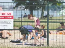  ?? DAN JANISSE ?? Sandpoint Beach is to reopen with lifeguards by Aug. 4. Fencing will be installed until then to keep crowds out.