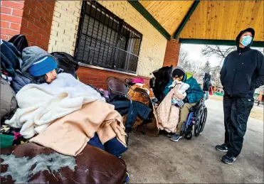  ?? Herald photo by Ian Martens ?? Street advocate and Kindness to Others founder Alvin Mills, at right, visits with a pair of residents after handing out some blankets earlier this week at Galt Gardens. @IMartensHe­rald