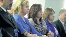  ??  ?? Sabine Durden, centre, of Mineral Spring, Arkansas, whose son Dominic Durden was killed in a traffic accident with an undocument­ed immigrant, holds hands with other victims’ family members during a news conference Wednesday.