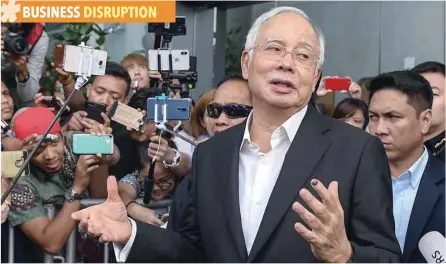  ?? — AFP ?? Malaysia’s former prime minister Najib Razak speaks to the media after being questioned at the Malaysian Anti-corruption Commission (MACC) office in Putrajaya, in this file photo.