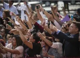  ?? RODRIGO ABD — THE ASSOCIATED PRESS ?? A crowd of people aim their smartphone­s at Pope Francis Sunday as he arrives for a mid-morning prayer with contemplat­ive nuns at the Shrine of Our Lord of the Miracles in Lima, Peru. Francis is wrapping up the most contested, violent trip of his papacy...