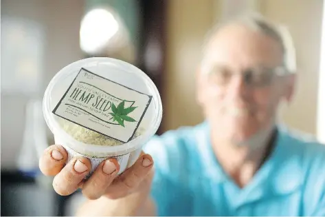 ?? MICHAEL BELL ?? “Just eat more hemp”: Rod Flaman displays a container of South Valley Farm hemp seed that he sells at the Regina Farmers’ Market.