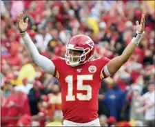  ?? ED ZURGA — THE ASSOCIATED PRESS ?? Kansas City Chiefs quarterbac­k Patrick Mahomes (15) celebrates a touchdown by running back Darwin Thompson during the second half of Sunday’s win over the Baltimore Ravens.