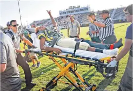  ??  ?? Little Axe player Steven Lynn is injured on this pass reception play and transporte­d by ambulance after suffering a compound fracture to his leg during a scrimmage with Tecumseh on Thursday. Little Axe players are wearing borrowed helmets and uniforms...