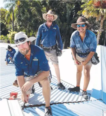  ?? Picture: ANNA ROGERS ?? TOUGH TIMES: Tropical Roofing and Drainage Solutions roofers Kevin Chapman, Ben Jackson, director/owner Rhys Littman and Sutchy Titasey work on a roof at Kewarra Beach.