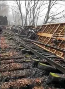  ?? PHOTO COURTESY OF THE UNION FIRE COMPANY ?? An East Penn train lies belly up on the tracks near Wilson Mill Road in Lower Oxford. The train was blown over by the wind on Friday afternoon.