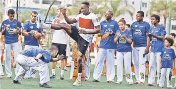  ?? — Reuters photo ?? England’s Danny Welback performs capoeira during a visit to a sports complex at the Rocinha slum in Rio de Janeiro ahead of the 2014 World Cup.