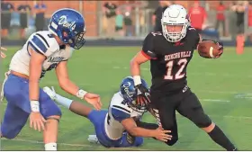  ?? Photos by LARRY GREESON / For the Calhoun Times ?? ( ABOVE) Sonoravill­e’s Case Collins (12) tries to break away from two Model defenders during the first half on Friday. ( BELOW) Sonoravill­e’s Robbie Hogg (29) and Colton Richards (26) combine to tackle Model’s Kidron Ford (6).