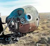  ?? RUSSIA DEFENSE MINISTRY ?? The Soyuz MS-10 space capsule, above, lies in a field after an emergency landing. NASA astronaut Nick Hague, center at left, and Russia’s Alexey Ovchinin were unharmed.