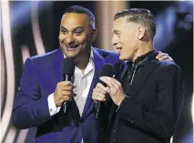  ?? LARS HAGBERG/AFP/GETTY IMAGES ?? Russell Peters, left, jokes with co-host Bryan Adams during the Juno Awards in Ottawa on Sunday night.