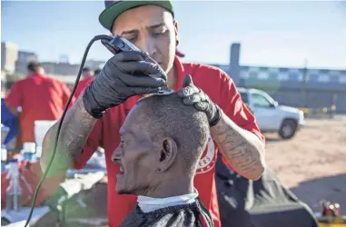  ?? PHOTOS BY NICK OZA/THE REPUBLIC ?? Michael Cardenas of Arizona Barbers Academy gives a haircut to Gary Corley, who is homeless, at St. Vincent de Paul’s Human Services Campus.