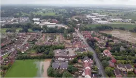  ??  ?? The Cheshire town of Poynton was hit by flash floods after heavy rain hit the area. Right, one resident tried to make the most of it after roads were flooded in Macclesfie­ld