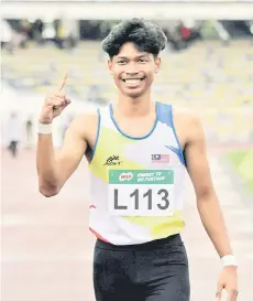  ?? — Bernama file photo ?? Azeem celebrates winning a 100m event.