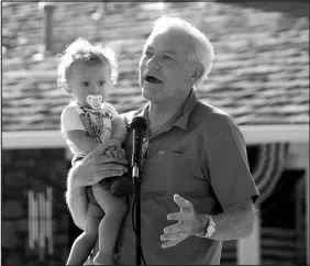  ?? JONATHAN J. COOPER / ASSOCIATED PRESS FILE (2023) ?? Rep. David Schweikert, R-ariz., holds his son Matthew while speaking at an Independen­ce Day parade July 4, 2023, in Phoenix. Schweikert, who has an A+ rating from Susan B. Anthony Pro-life America, said the issue of abortion should be decided by voters, “not legislated from the bench.”