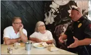  ?? MEDIANEWS GROUP FILE PHOTO ?? John Scalia, right, has resigned as Caernarvon Township police chief. Above, he is talking to Scott and Kathy Kulp of Elverson during a Coffee with a Cop event in July 2019.