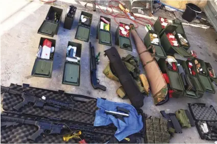  ?? Long Beach PoLIce DePartment VIa aP ?? This undated file photo released by the Long Beach, Calif., Police Department shows weapons and ammunition seized from a cook at a Los Angeles-area hotel who allegedly threatened a mass shooting.