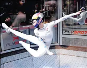  ?? JANEK SKARZYNSKI/AFP ?? Maja Kuczynska, 17, makes airborne gymnastic moves during her skydiving performanc­e inside a wind tunnel, in the Polish capital Warsaw, on February 19.