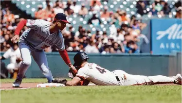  ?? Santiago Mejia/The Chronicle ?? Giants center fielder Tyler Fitzgerald swiped second and third base in the second inning of Wednesday’s game against the Washington Nationals, the team’s first two stolen bases of the season.