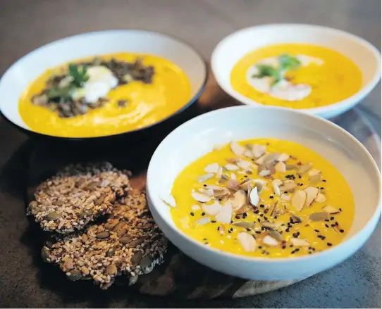  ?? ALLEN McINNIS ?? Three garnishes for butternut squash velouté from Josée di Stasio’s new book, clockwise from left, lentils, shallots and Italian parsley, with yogurt and citrus zest; a simpler version with just the yogurt plus sumac and coriander; and a version with pumpkin seeds, sesame seeds and flaked almonds, all toasted.