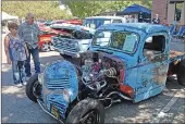  ??  ?? Attendees look at a souped-up Dodge truck during Saturday’s 10th annual Historic Downtown Marysville Car and Bike Show on D Street.