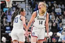  ?? Jessica Hill/Associated Press ?? UConn’s Nika Muhl (10) celebrates with Dorka Juhasz after Juhasz hit a 3-point basket during the first half against Florida State in December.