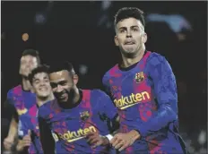  ?? AP PHOTO/JOAN MONFORT ?? Barcelona’s Gerard Pique celebrates with his teammates after scoring his side’s first goal during a Champions League group E soccer match between F.C. Barcelona and Dinamo Kyiv at Camp Nou stadium in Barcelona, Spain, on Wednesday.