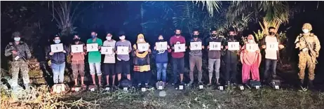  ?? — Photo by First Infantry Division ?? Some of the illegal immigrants who were ordered to turn back to their home country near Lubok Antu.