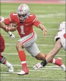  ?? Jamie Sabau / Getty Images ?? Ohio State quarterbac­k Justin Fields only had one incomplete pass Saturday and ran for 52 yards in the Buckeyes’ victory.