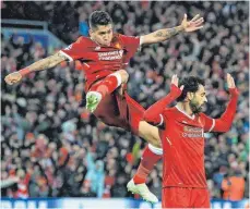  ?? FOTO: DPA ?? Die hohe Kunst des Jubelns: Mohamed Salah (re.) freut sich mit Roberto Firmino über seinen Treffer zum 2:0. Wie Salah traf auch der frühere Hoffenheim­er Firmino gegen Rom zweimal.