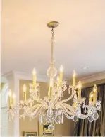  ??  ?? The crystal chandelier is a focal point in the couple’s formal dining room. Val sourced many of the pendants from small markets throughout Europe.