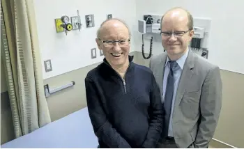  ?? JEFF MCINTOSH/THE CANADIAN PRESS ?? ALS patient Cliff Barr, left, who is taking part in a new Canada-wide clinical trial to treat ALS, poses in an examinatio­n room with trial leader Dr. Lawrence Korngut, in Calgary on Thursday.