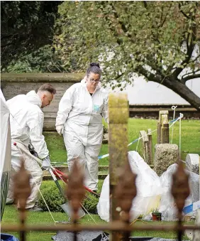  ?? SWNS ?? > Wiltshire Police cordoned off part of a graveyard at St Andrew’s Church in Collingbou­rne Ducis on Monday