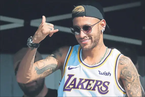  ?? FOTO: EFE ?? Preocupado no parece Neymar posó con la camiseta de los Lakers ayer durante su visita al Mundial de Surf en Portugal