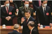  ?? KEVIN FRAYER/GETTY ?? Chinese President Xi Jinping waves to senior officials on Sunday as he leaves the opening ceremony of the Communist Party congress in Beijing.