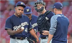  ?? DAVID KOHL / USA TODAY SPORTS ?? Brewers starter Junior Guerra gives ball to manager Craig Counsell in second inning Tuesday.