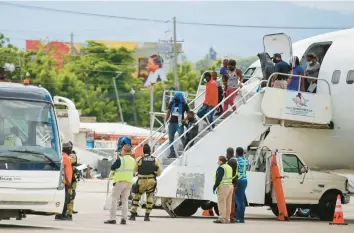  ?? ODELYN JOSEPH/AP ?? Haitians who were deported from the United States disembark Sept. 19, 2021, at the Toussaint L’Ouverture Internatio­nal Airport in Port au Prince, Haiti. More than 20,000 Haitians have been deported from the U.S. in the past year.