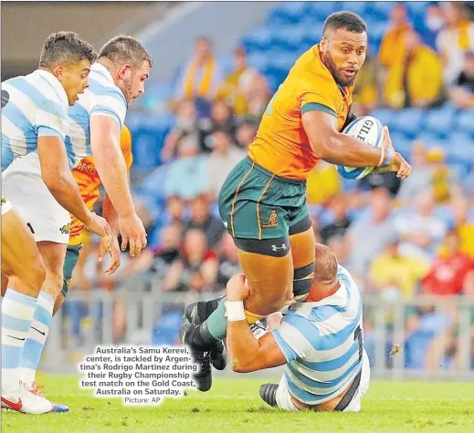  ?? Picture: AP ?? Australia’s Samu Kerevi, center, is tackled by Argentina’s Rodrigo Martinez during their Rugby Championsh­ip test match on the Gold Coast, Australia on Saturday.