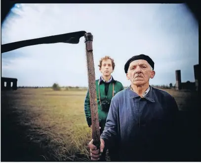  ??  ?? Local resident with scythe and self-portrait, Auschwitz ll (Birkenau) concentrat­ion camp, Oswiecim, Poland, 1983