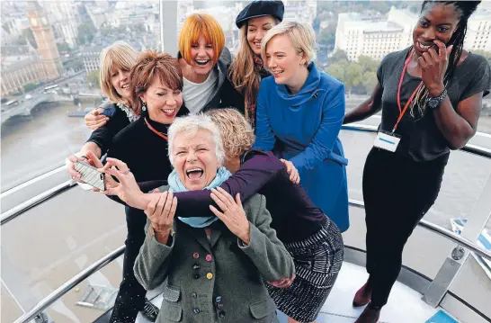  ??  ?? Acci-dental experience: Julie Walters shows off her pearly whites while posing for a selfie in the London Eye during an event with girls from London’s Dunraven School.