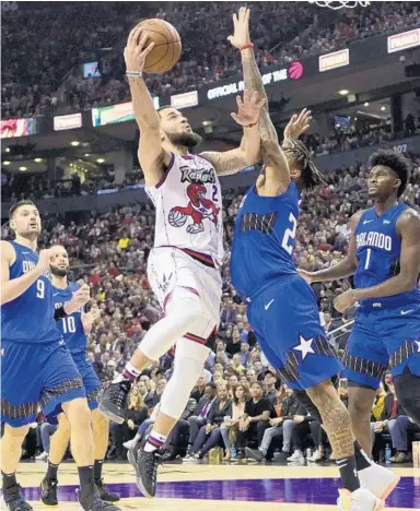  ?? FRANK GUNN/AP ?? Raptors guard Fred VanVleet goes up to shoot as Magic guard Markelle Fultz (20) defends during the first half Monday night in Toronto. The Raptors, who eliminated the Magic from the 2019 playoffs, won 104-95.