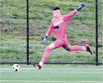  ?? Photograph­s by AMANDA EMARY. ?? Right: Keeper Aiden Riley kicks long during Saturday’s game at Baxter Park.
United lost 1-2.