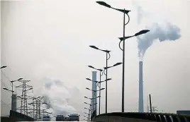  ??  ?? Smoke rises from chimneys of a steel plant in Hebei province, China. — Reuters