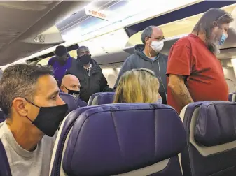  ?? Preston Gannaway / Special to The chronicle ?? Passengers board a flight to Oakland on Nov. 15. COVID19 cases are increasing rapidly, and holiday events are likely to add to the surge that’s causing hospitals to prepare for the worst.